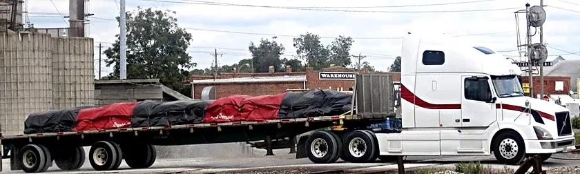 Picture of vinyl lumber tarp for for flatbed trucks with 6-foot side drops, from American Tarping.